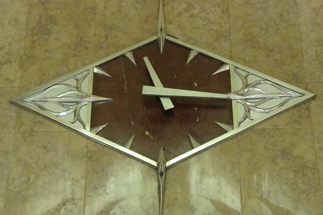 An Art Deco wall clock with slim metal hands